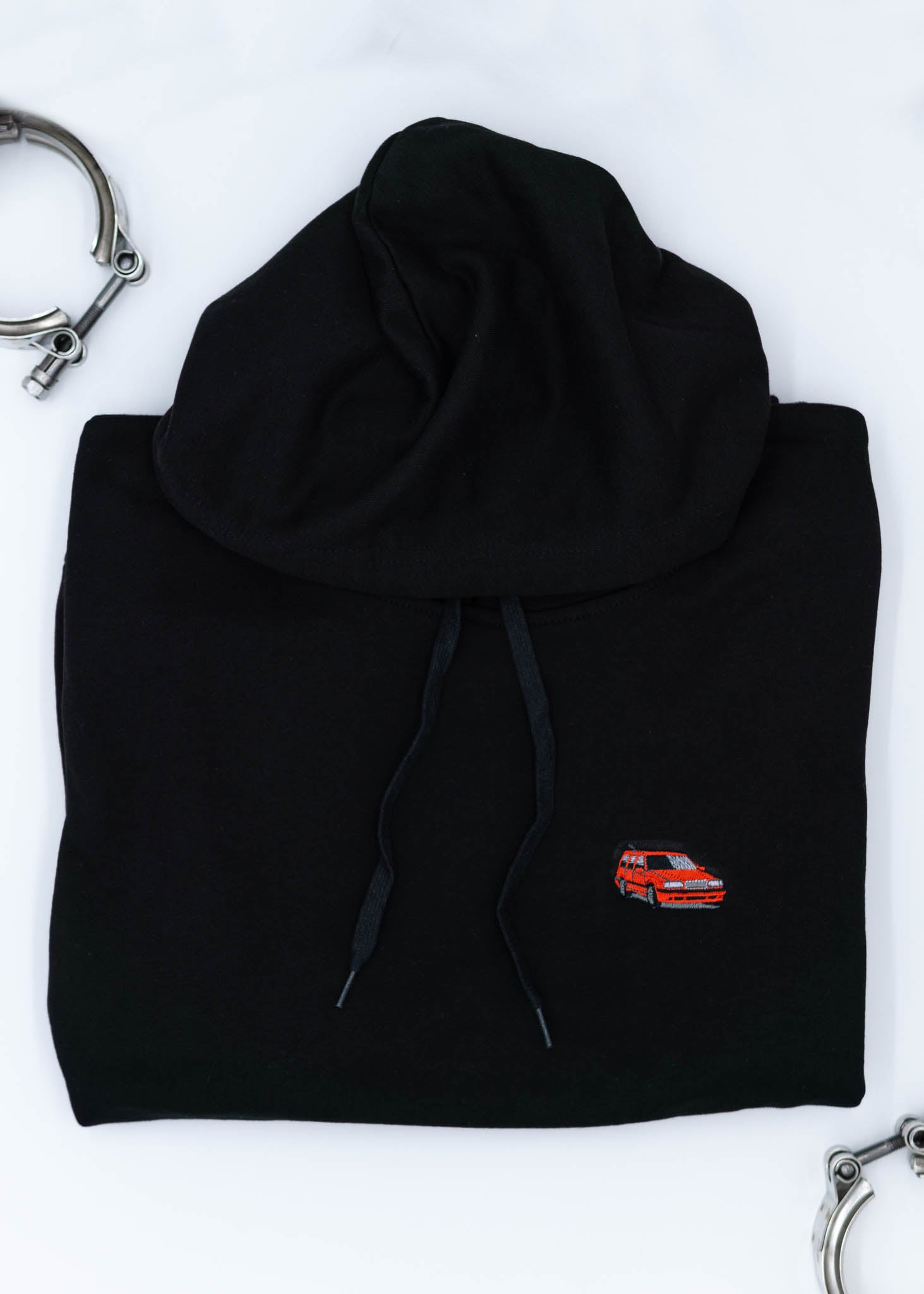 A black Volvo unisex hoodie for men and women. Photo is a close up view of the sweater with an embroidered Volvo 850R. Fabric composition is cotton, polyester, and rayon. The material is very soft, stretchy, and non-transparent. The style of this hoodie is long sleeve, crewneck with a hood, hooded, with embroidery on the left chest.