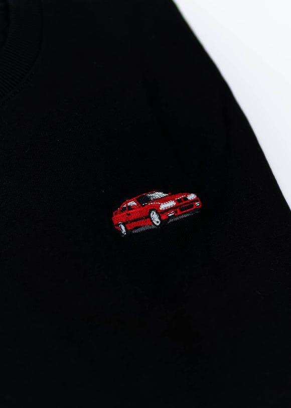 A black E36 M3 crewneck sweater for men. Photo is a close up view of the sweater with an embroidered E36 M3. Fabric is a cotton and polyester mix and high quality and fits to size. The style is long sleeve, crew neck, and embroidery on left chest.