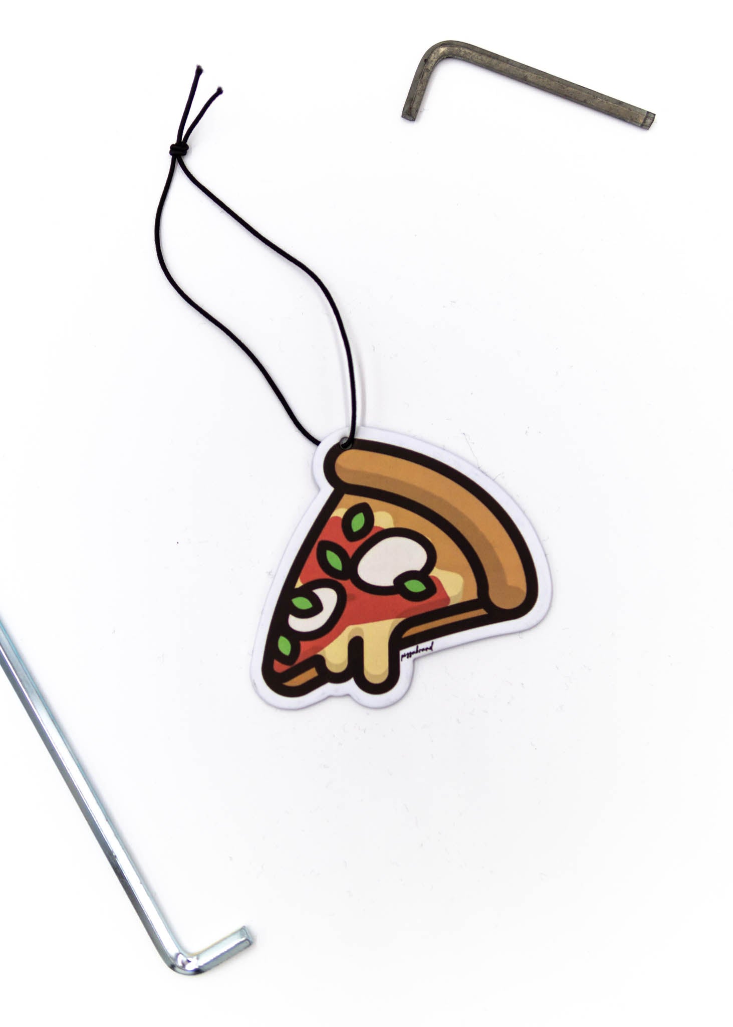 A pizzabrand margherita pizza air freshener. Photo is a close up of the car air freshener with string.
