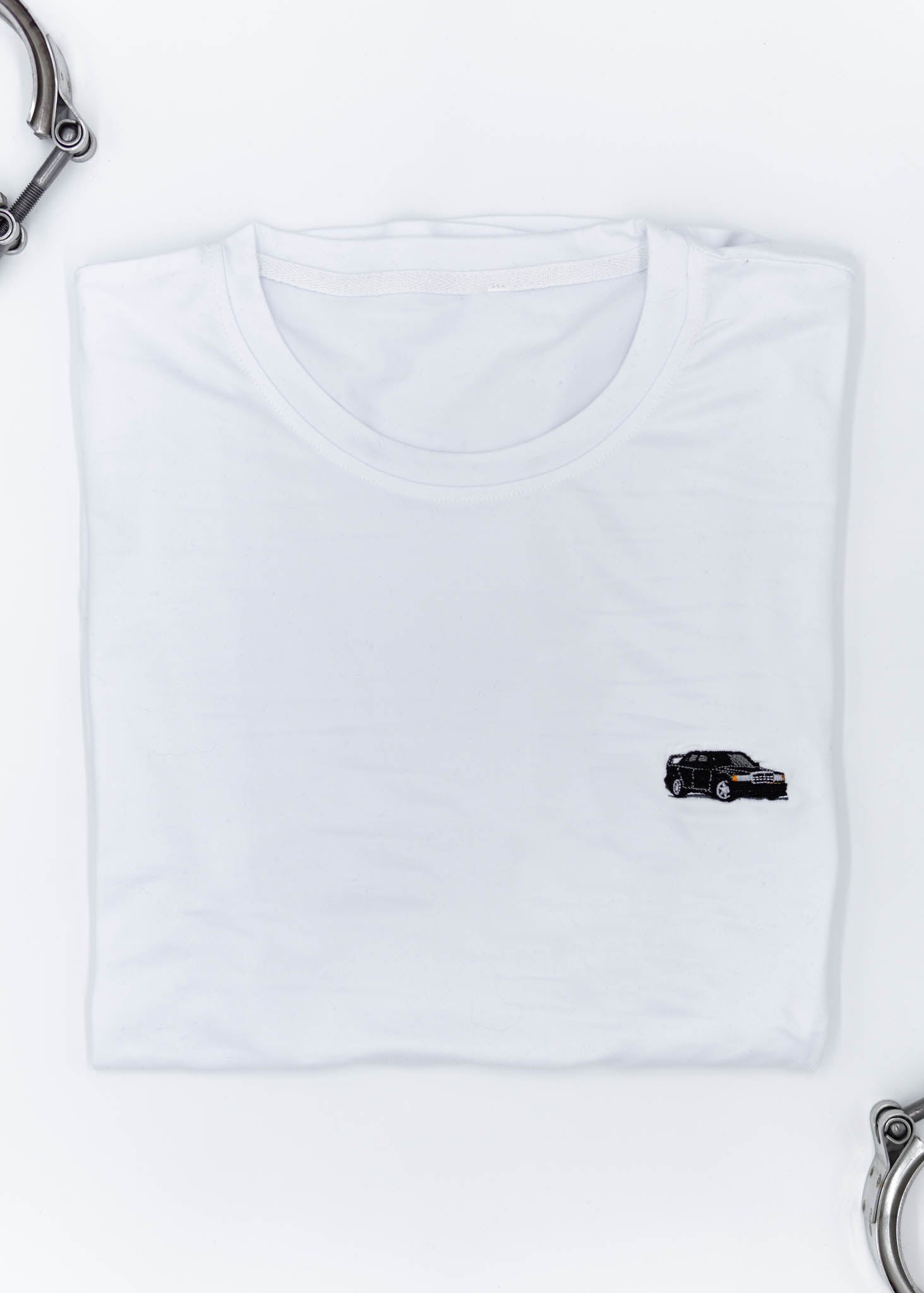 A white Mercedes-Benz t-shirt for men. Photo is a close up view of the shirt with an embroidered black W201 190E 2.5-16 Evo II. Fabric composition is a polyester, and cotton mix. The material is very soft, stretchy, non-transparent. The style of this shirt is short sleeve, with a crewneck neckline.