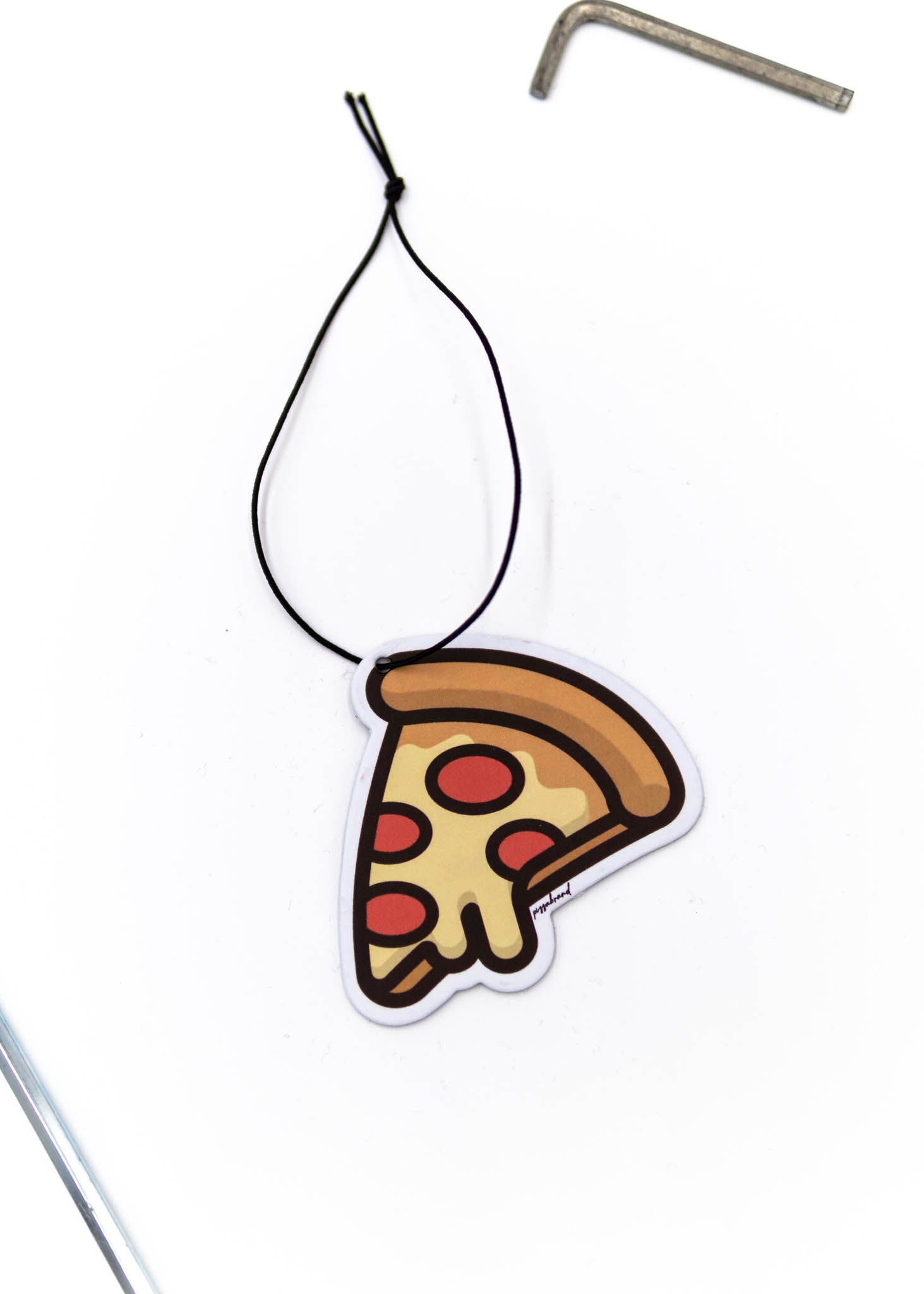 A pizzabrand pepperoni pizza air freshener. Photo is a close up of the car air freshener with string.