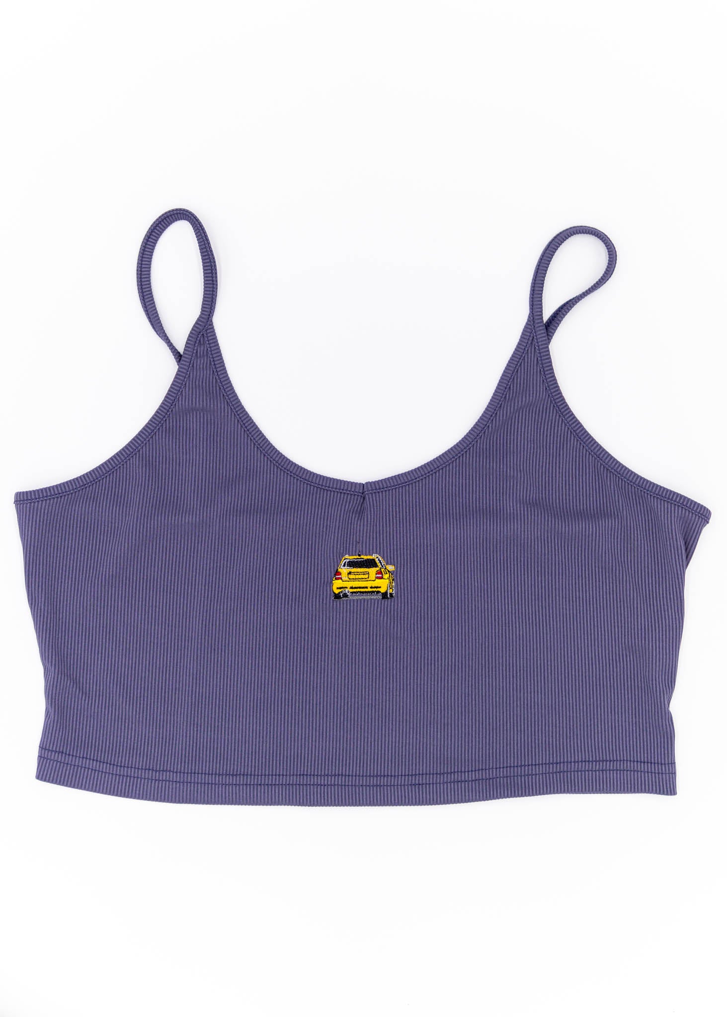 A purple Audi crop top for plus size women. Photo is a front view of the top with an embroidered Imola Yellow Audi B5 RS4. Fabric composition is polyester, and spandex. The material is stretchy, ribbed, and non-transparent. The style of this shirt is sleeveless, with a deep neckline.