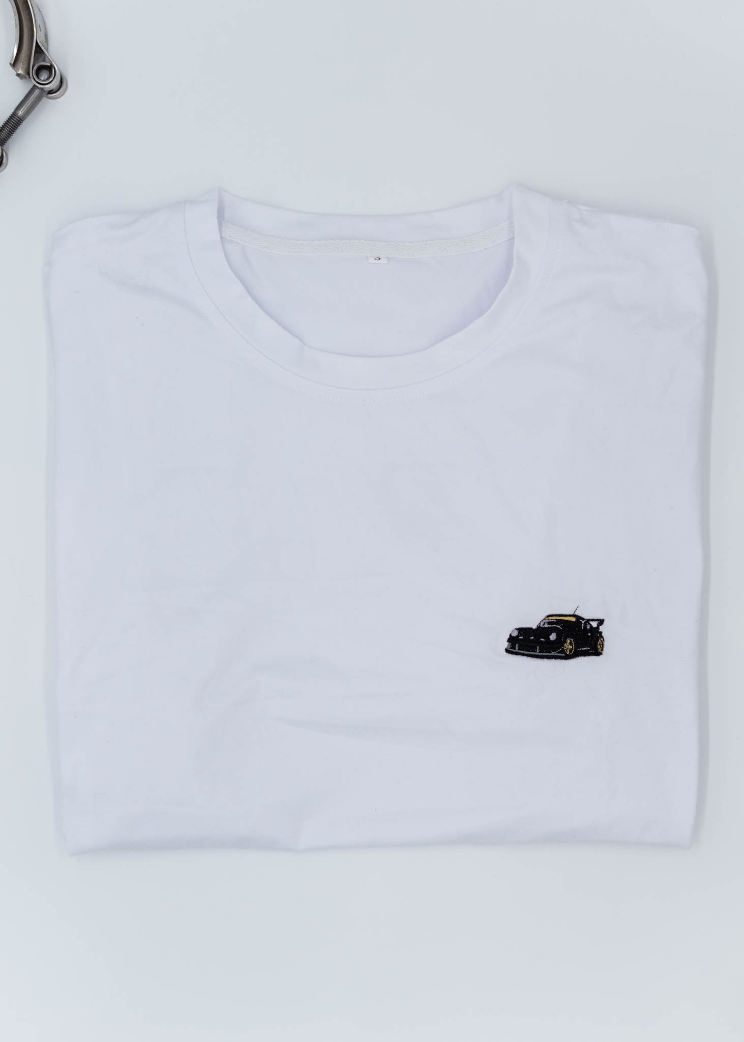 A white Porsche T-Shirt for men. Photo is a front view of the shirt with an embroidered RWB Porsche 930 911 Turbo Stella Artois. Fabric composition is 100% polyester. The material is very stretchy, soft, comfortable, breathable, and non-transparent. The style of this shirt is short sleeve, with a crewneck neckline.